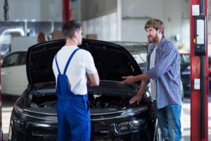 Client and mechanic talking about the delayed car repair