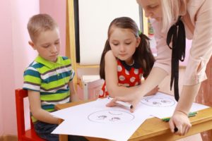 Two Children Showing Their Drawing