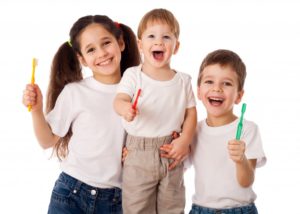 kids holding toothbrushes 