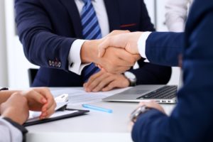 Businessmen shaking hands after negotiation