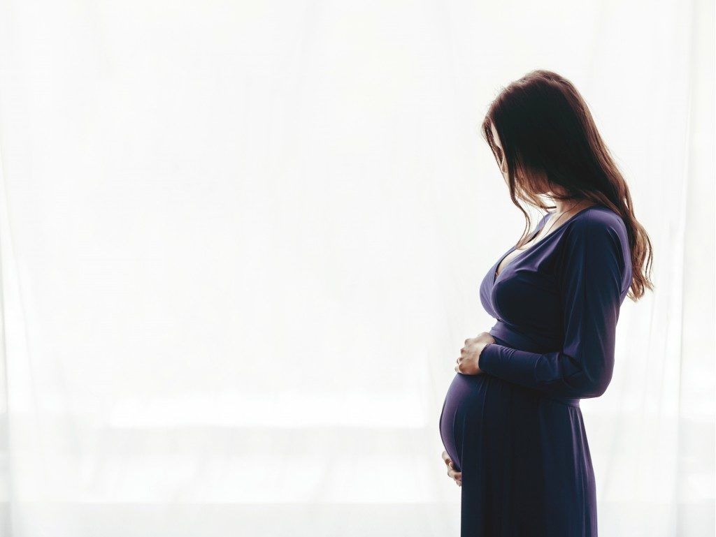 Pregnant woman in side view