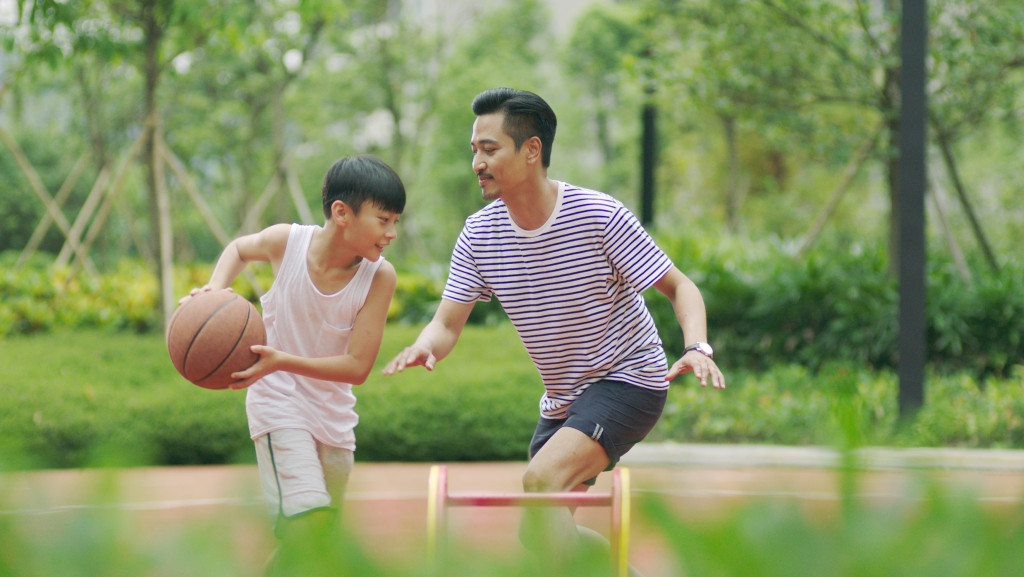 Dad and son playing basketball