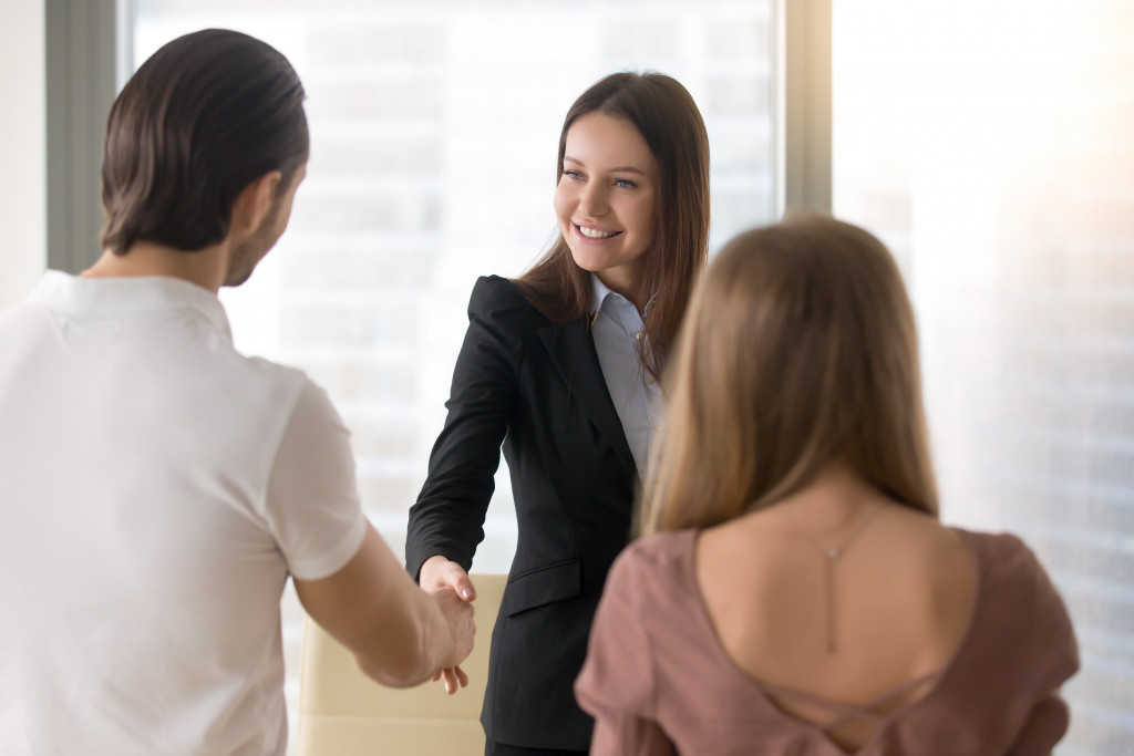 A businesswoman shaking hands with customers