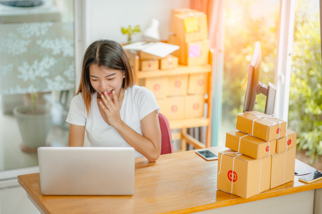 Young woman starting new business receiving online orders