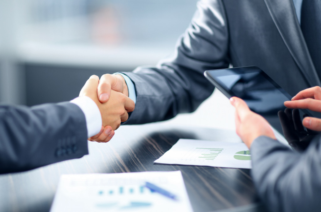 Two business professionals shaking hands in an office