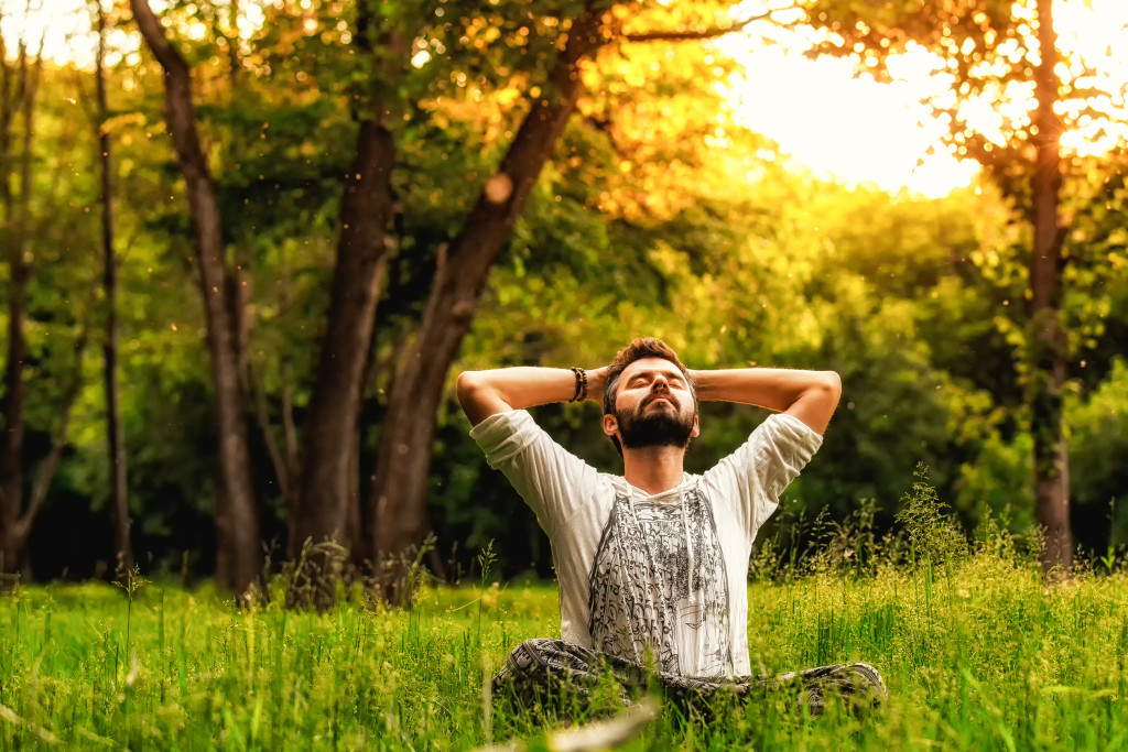 A man meditating outdoors